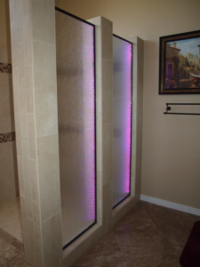 A modern shower area featuring custom illuminated glass panels installed by Cohaco Building Specialties in Peoria, AZ.