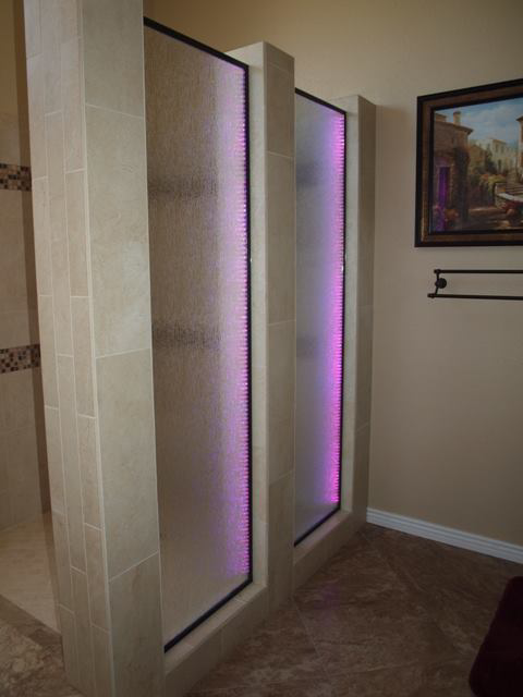 A modern shower area featuring custom illuminated glass panels installed by Cohaco Building Specialties in Peoria, AZ.