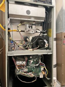 Internal components of an indoor furnace serviced by Allred Heating Cooling Electric in Auburn, WA.