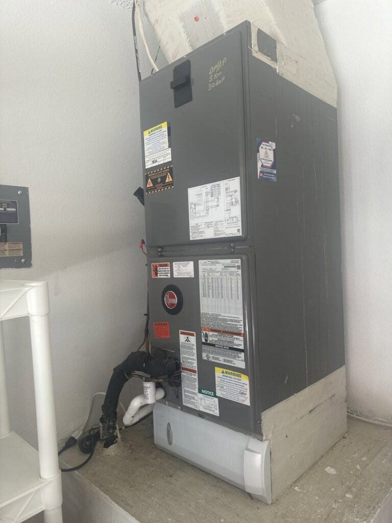 An indoor HVAC air handler unit installed in a utility closet by Our Place Air & Home Repair in Orlando, FL.