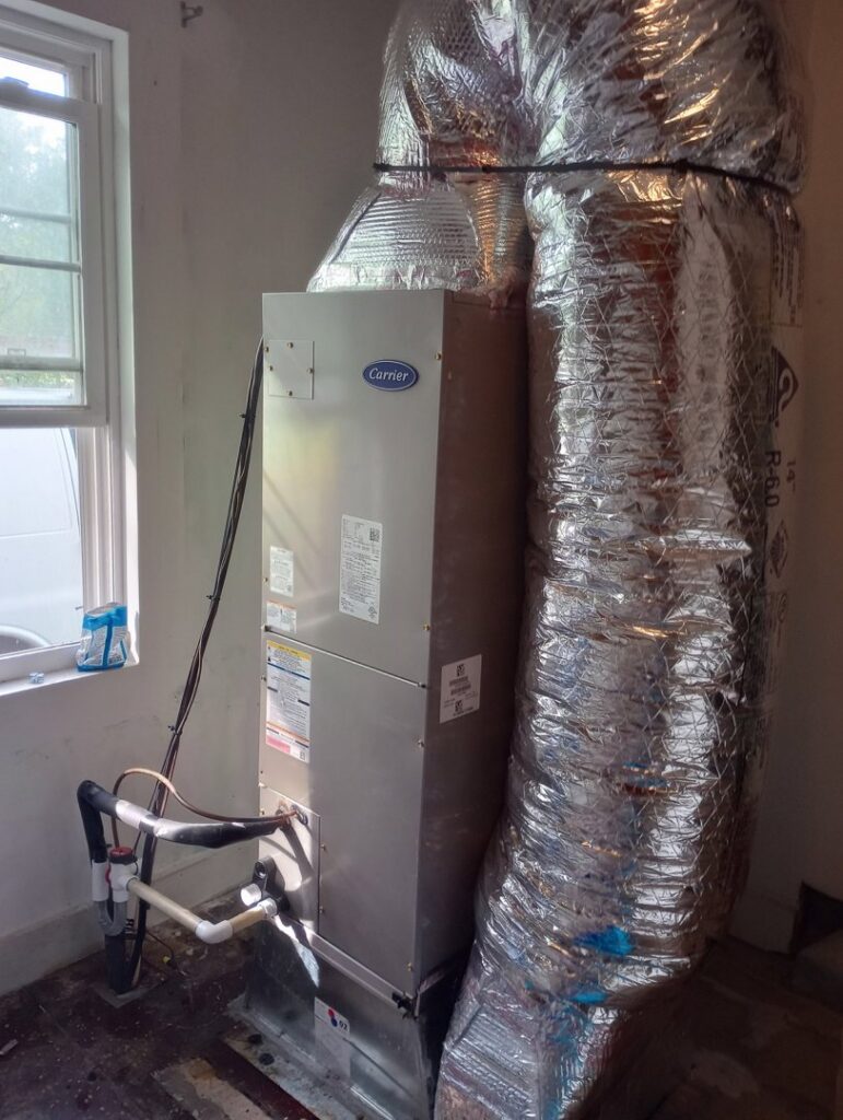 An indoor HVAC furnace or air handler unit with connected ductwork, installed by Pollock HVAC & Electrical in Albany, GA