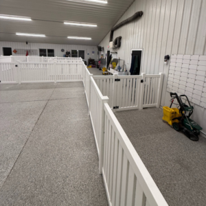 White fencing and enclosures installed inside an indoor facility by A to Z Quality Fencing and Structures-Appleton, WI.