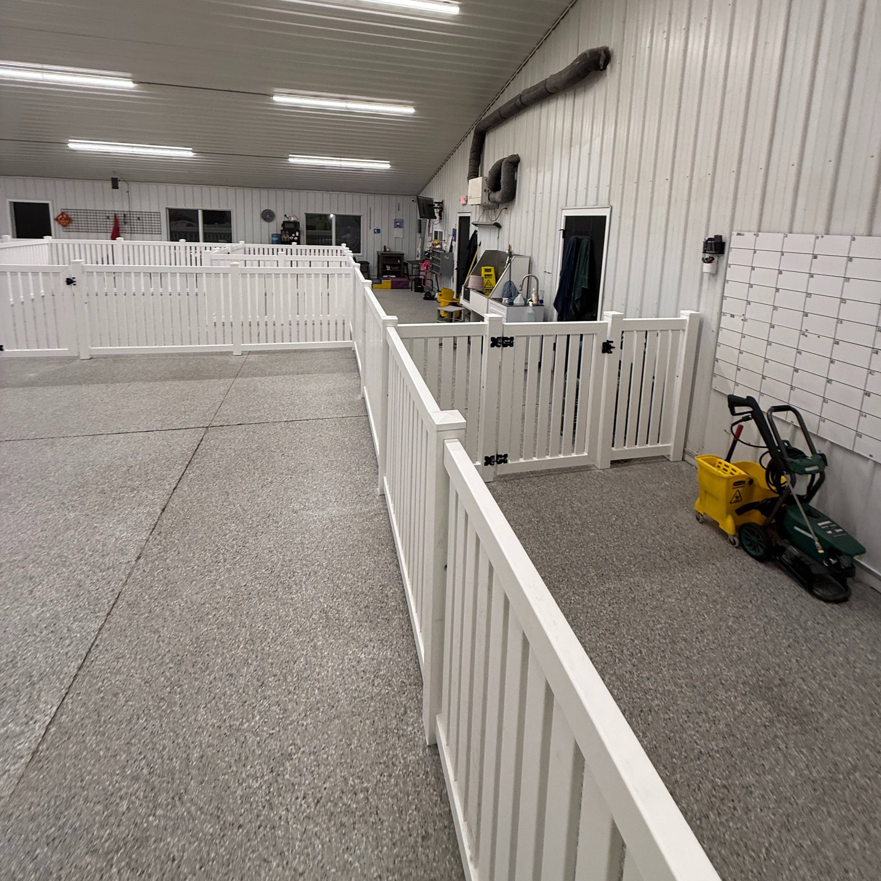 White fencing and enclosures installed inside an indoor facility by A to Z Quality Fencing and Structures-Appleton, WI.