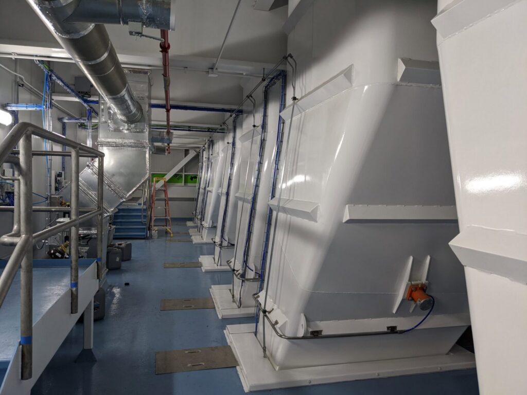 A clean industrial interior with large white structures and painted floors by Harpeth Painting, LLC. in Nashville, TN.