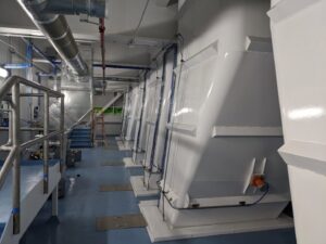 A clean industrial interior with large white structures and painted floors by Harpeth Painting, LLC. in Nashville, TN.