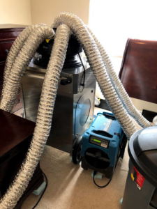 An industrial dehumidifier and drying ducts used for water damage restoration by ProTouch Restoration in Minneapolis, MN.