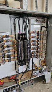 Complex industrial electrical panel with extensive wiring and components, serviced by Denali Electric LLC in San Antonio, TX