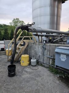 Close-up of industrial pipes and equipment at the Northeast-Paving asphalt plant in Bangor, ME