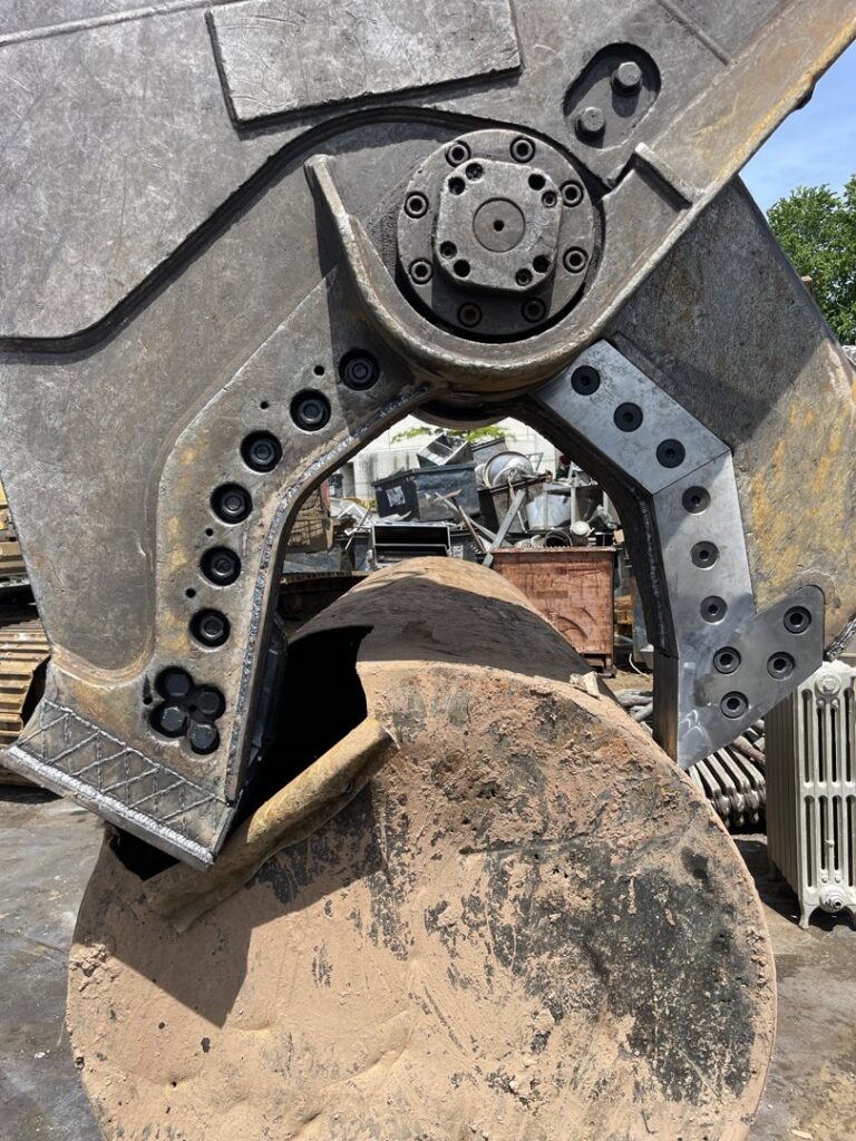 A large industrial metal shear processing scrap metal at the facility of All American Alloys and Recycling Inc. in Elizabeth, NJ.