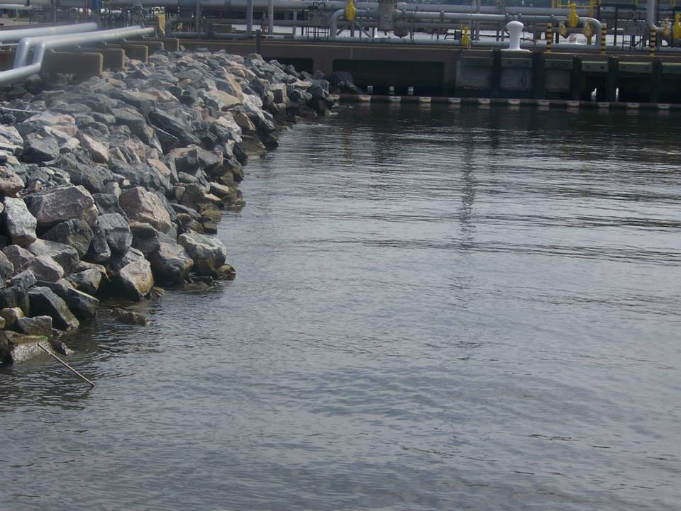 A robust rock revetment protecting an industrial waterfront, installed by Spence Marine Construction Inc. in Virginia Beach, VA.