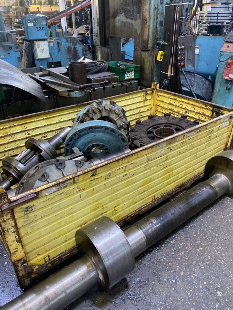 A yellow bin filled with industrial scrap metal parts ready for removal by Remove Recycle Remarket in Troy, MI.