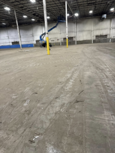An industrial space with debris on the floor during a cleanout service by Remove Recycle Remarket in Troy, MI.
