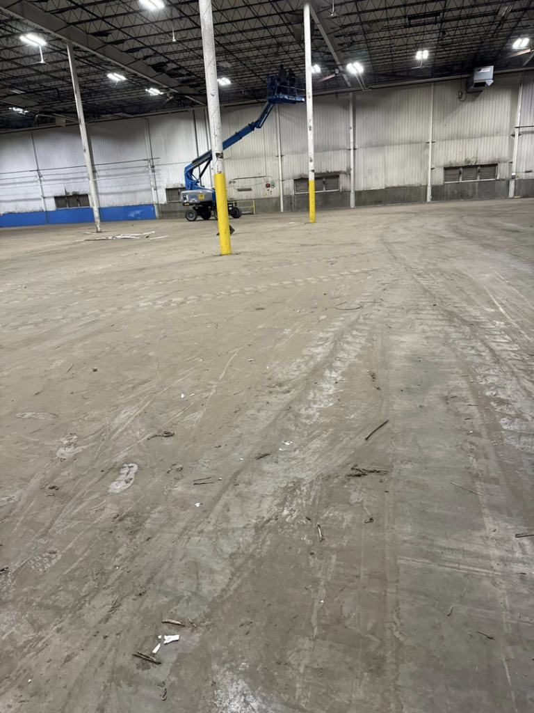 An industrial space with debris on the floor during a cleanout service by Remove Recycle Remarket in Troy, MI.