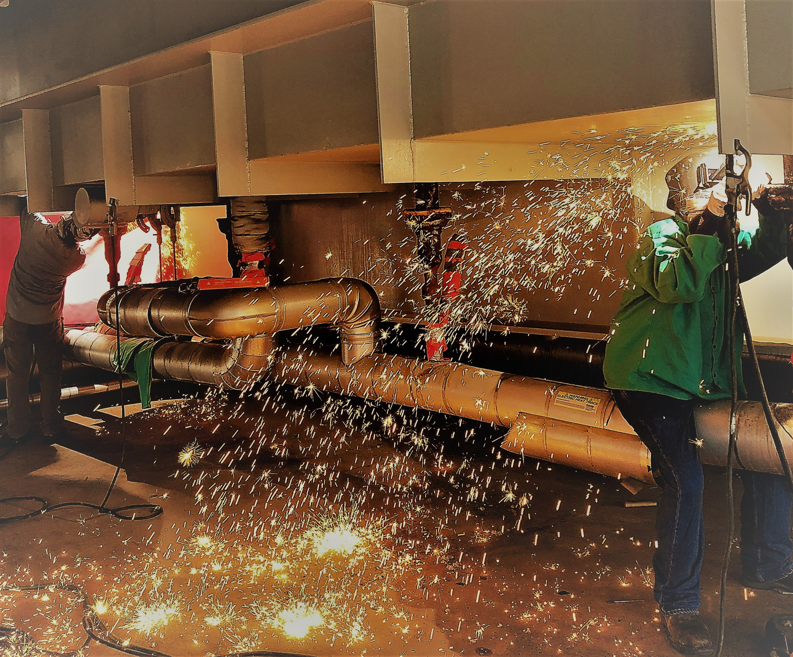 Two workers performing industrial welding and fabrication services at Accurity Industrial Contractors, Inc. in Owensboro, KY