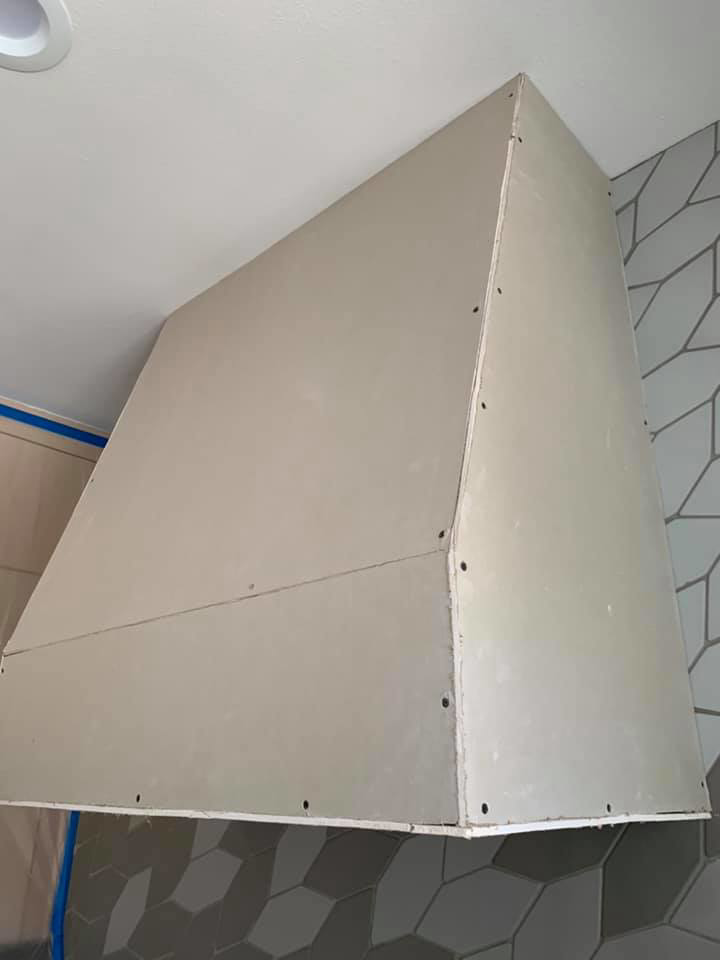 Initial drywall framing for a custom range hood project by Plasters of Italy in Plano, TX