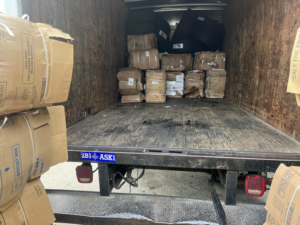 Inside a box truck showing baled cardboard boxes and tires for E&k logistics an Recycling LLC in Hoover, AL.