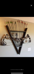 An installed custom wood bow and arrow rack by Don's Custom Woodwork in Jefferson City, MO.
