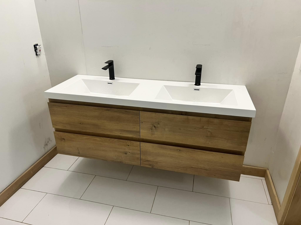 A newly installed double floating bathroom vanity with black faucets by Armbruster General Contracting in Cincinnati, OH.