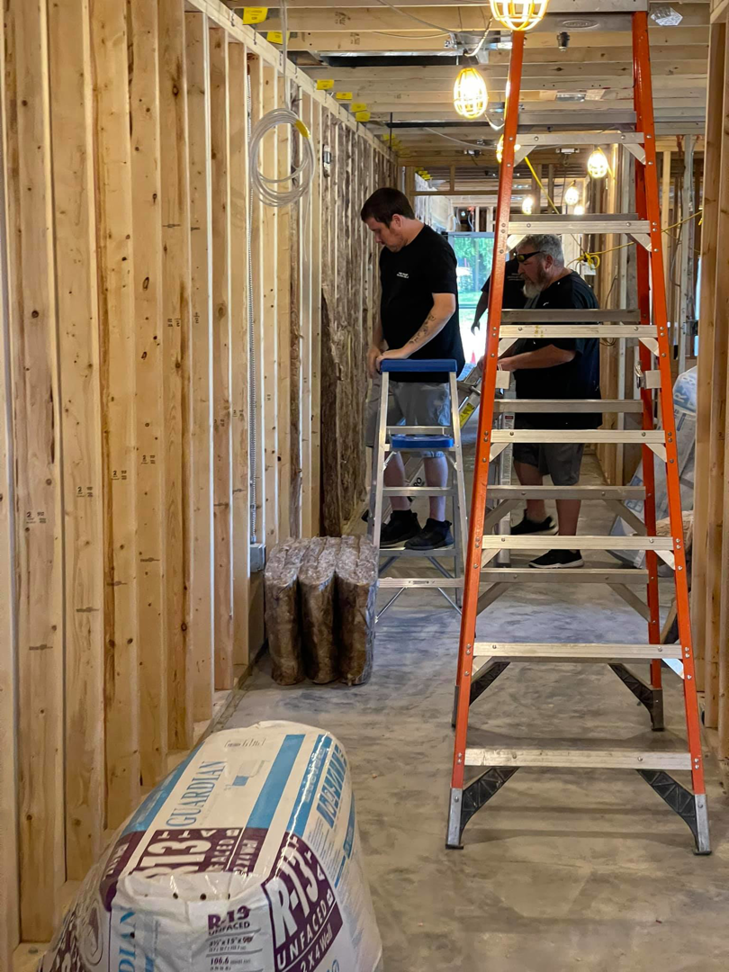Insulation contractors working on a construction site with insulation materials for Miami Valley Insulation Co LLC in Dayton, OH.