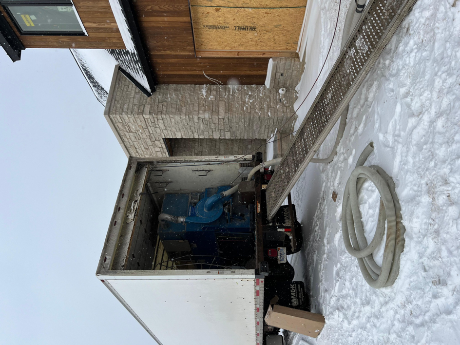 Insulation equipment being unloaded from a truck for a job site by Insulation Man in Chesterfield, MI.