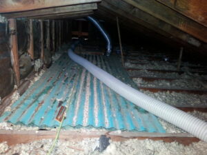 An insulation hose being used to install insulation in an attic by ADDICT INSULATION, LLC in St. Charles, MO.