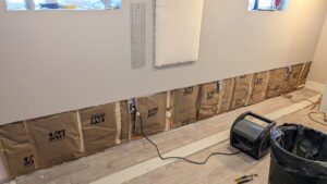 Insulation being installed in an interior wall during a repair project by SurePlan Handyman in North Ogden, UT