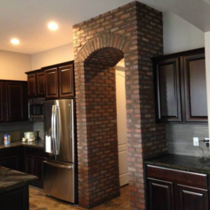 An interior kitchen featuring a custom brick archway installed by Ken's Masonry, LLC in Chandler, AZ.