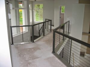 Interior cable railings for a staircase and landing installed by Xclusive Fence And Rails Inc. in Miami, FL.