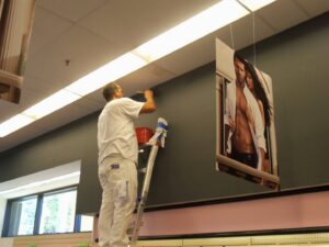 A worker on a ladder performing an interior ceiling painting project for Vico Painting Contractors in Hialeah, FL