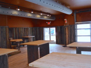 Interior commercial build-out with wooden tables and wall paneling by Triad Construction Company LLC in Ashland City, TN.