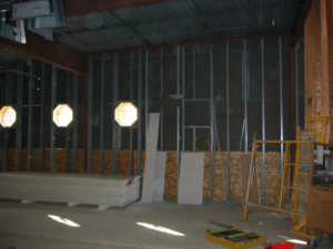 Interior construction showing metal wall framing and stacks of drywall for a project by Milestone Construction in Wichita, KS