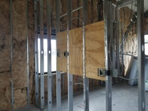 Interior construction showing metal studs, insulation, and electrical work by Reeder General Contractors, Inc. in Fort Worth, TX