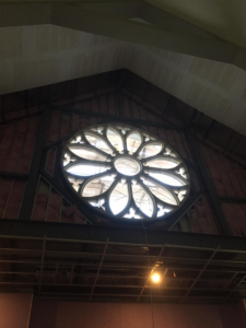 Interior view of a building under construction, featuring a large rose window, by Dallas Cast Stone in Dallas, TX