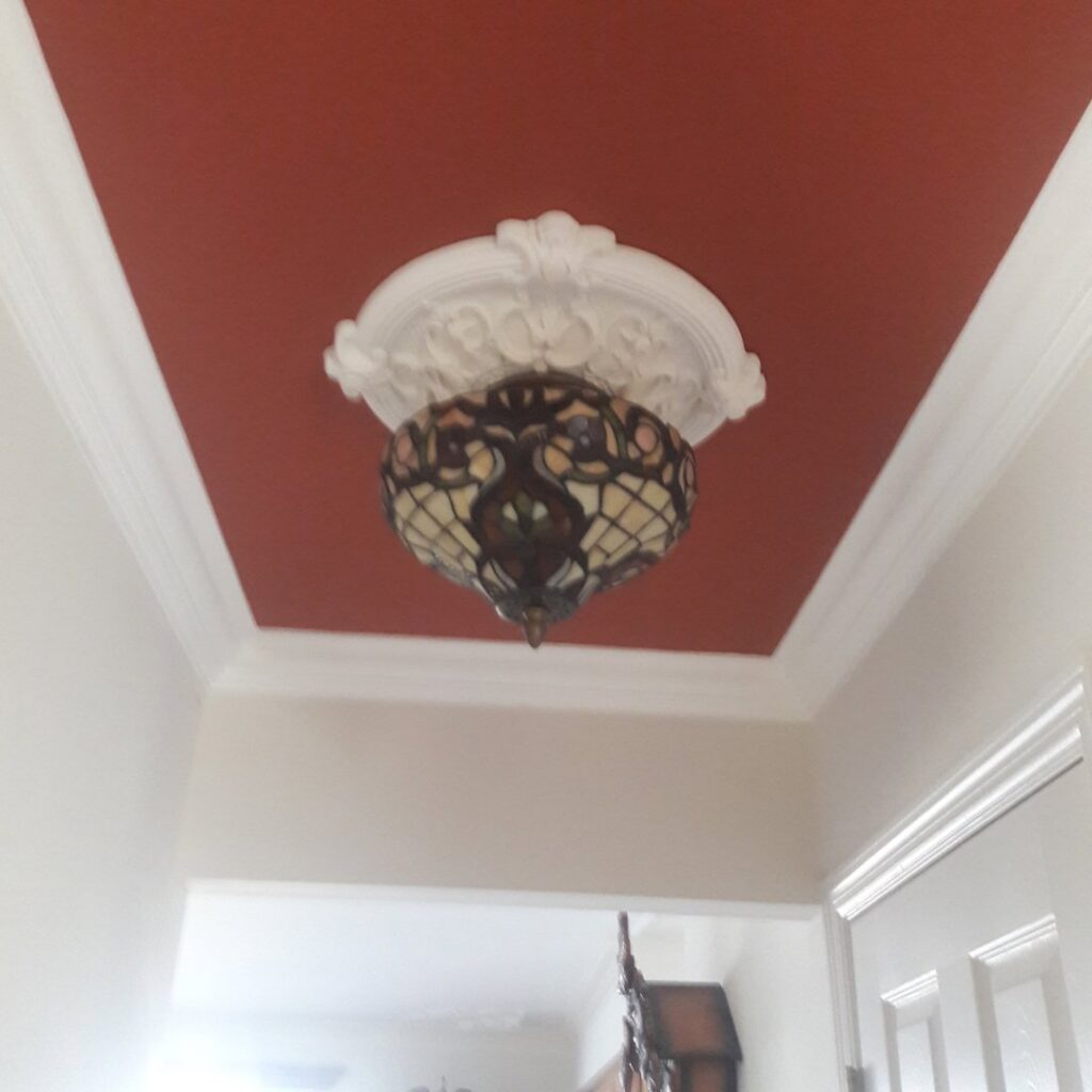 Interior room showcasing new crown molding and window shutters installed by Borrelli Plastering & Sons in O'Fallon, MO.