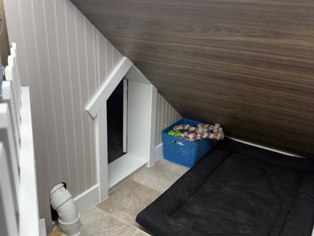 The interior of a custom-built dog nook under stairs by JJ's Handyman Service in Las Vegas, NV
