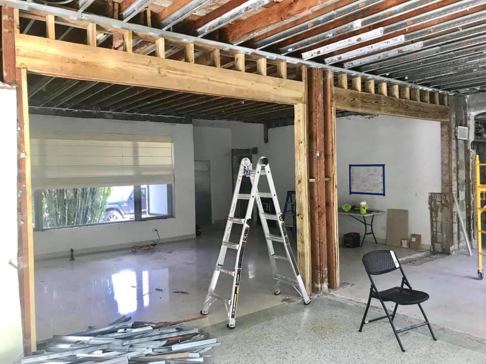 An interior building renovation project showing exposed ceiling joists and wall framing by Snapp Industries, Inc. in Miami, FL