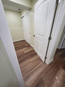 New interior doors and wood-look laminate flooring installed by Top Gunn Family Construction in Truxton, MO.