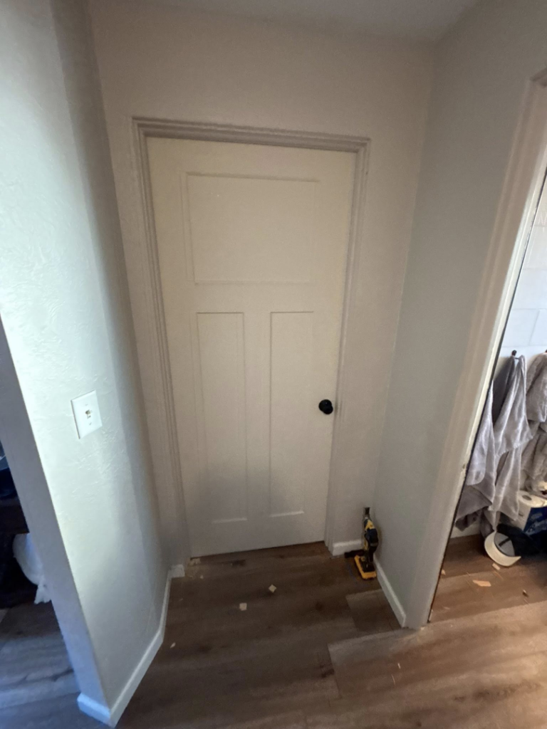 An interior renovation project showing new door and flooring installation by J Webb's Home Improvements LLC in Peoria, IL.