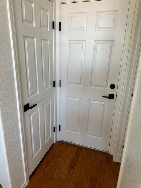 Newly installed black door handles on white interior doors by Henderson Handyman in Henderson, NV