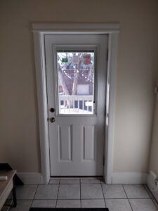 Newly installed interior door with a glass panel by Colorado Window Solutions in Denver, CO.