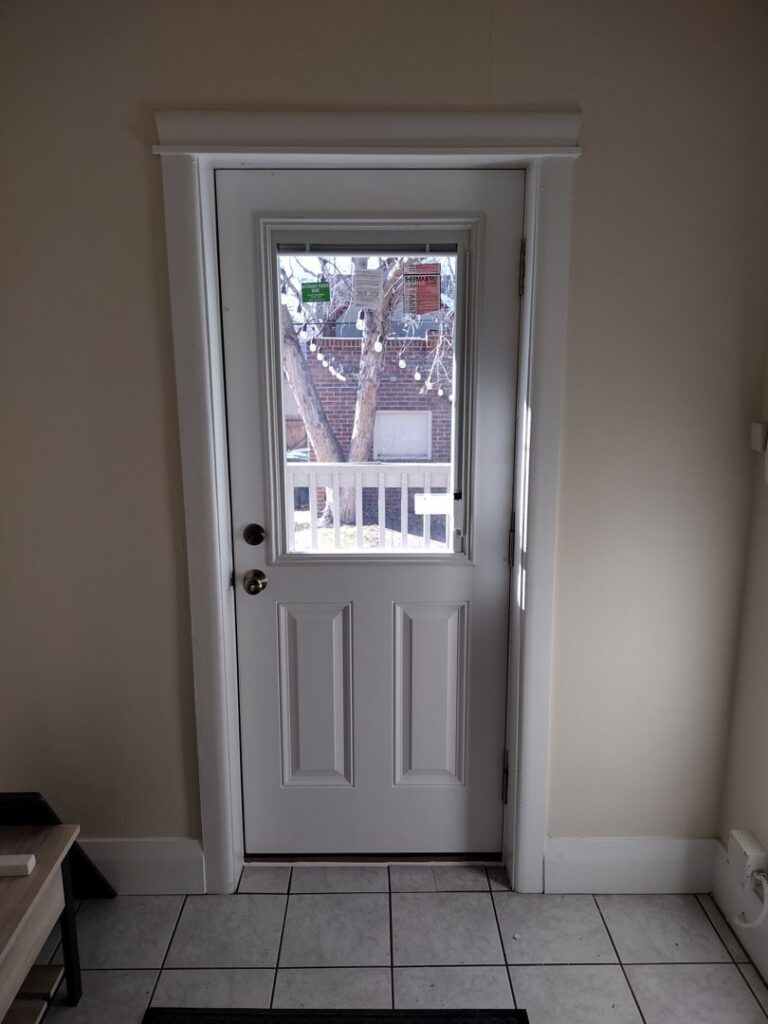 Newly installed interior door with a glass panel by Colorado Window Solutions in Denver, CO.