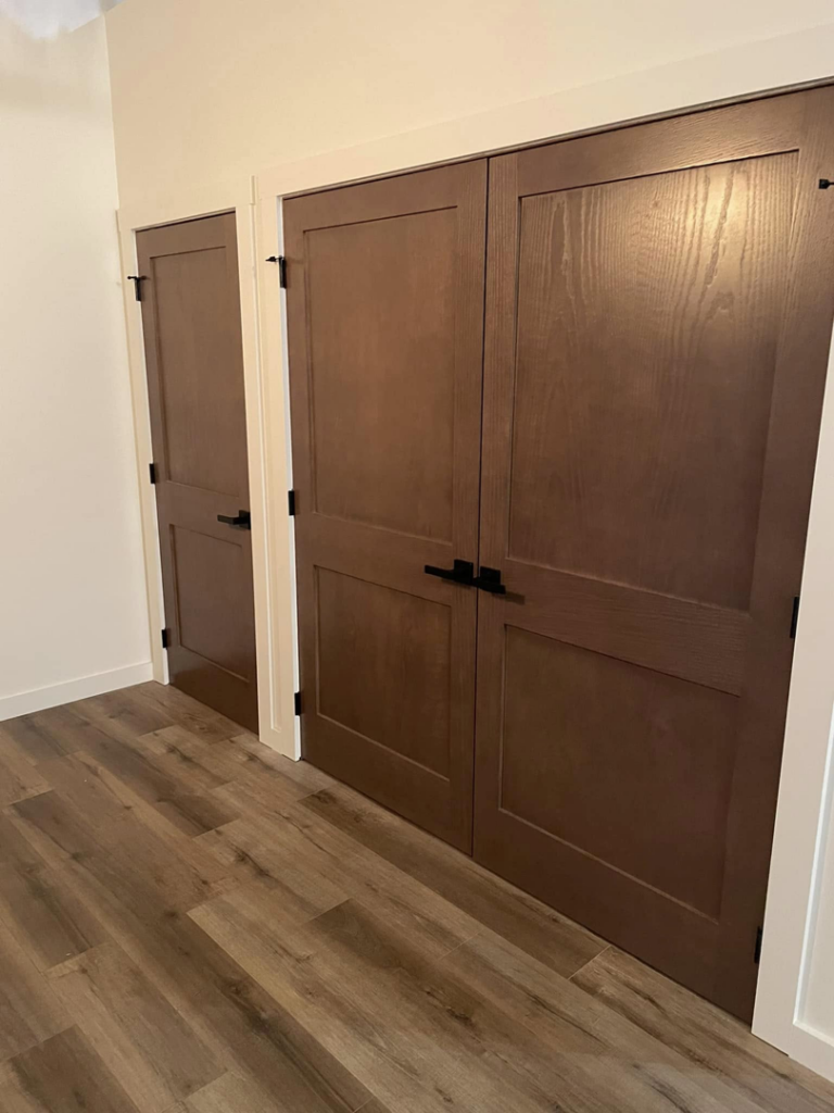 Interior wooden door installation with black hardware and white trim by DeJean Home Renovation in Yankton, SD.