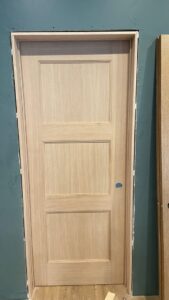 A newly installed interior wooden door and frame, ready for finishing, by T&K Services in Idaho Falls, ID