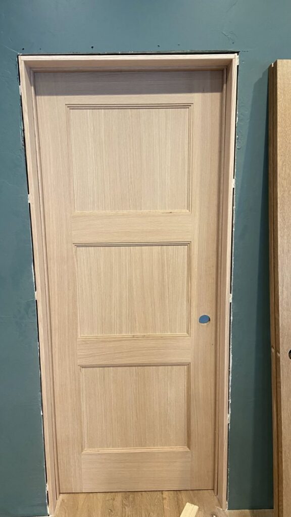 A newly installed interior wooden door and frame, ready for finishing, by T&K Services in Idaho Falls, ID