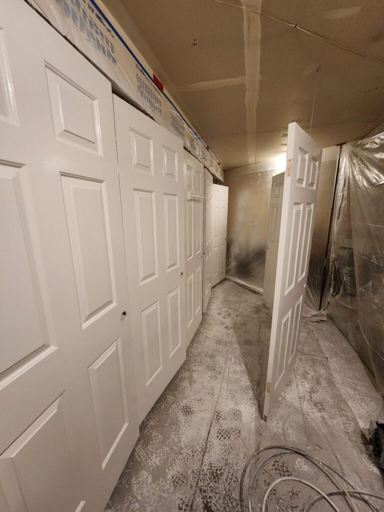 Interior doors being painted or installed in a hallway, showcasing services by Branham Handyman in Salt Lake City, UT