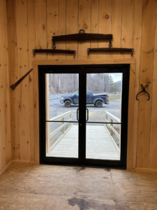 Interior view of newly installed double doors and wooden ramp by Next Generation Carpentry LLC in Bennington, VT.
