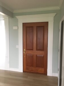 A beautifully installed interior door with detailed trim work by BizMick Construction in Coventry, RI.