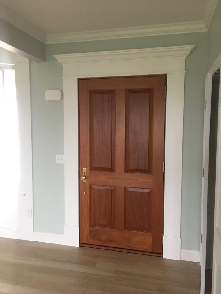 A beautifully installed interior door with detailed trim work by BizMick Construction in Coventry, RI.
