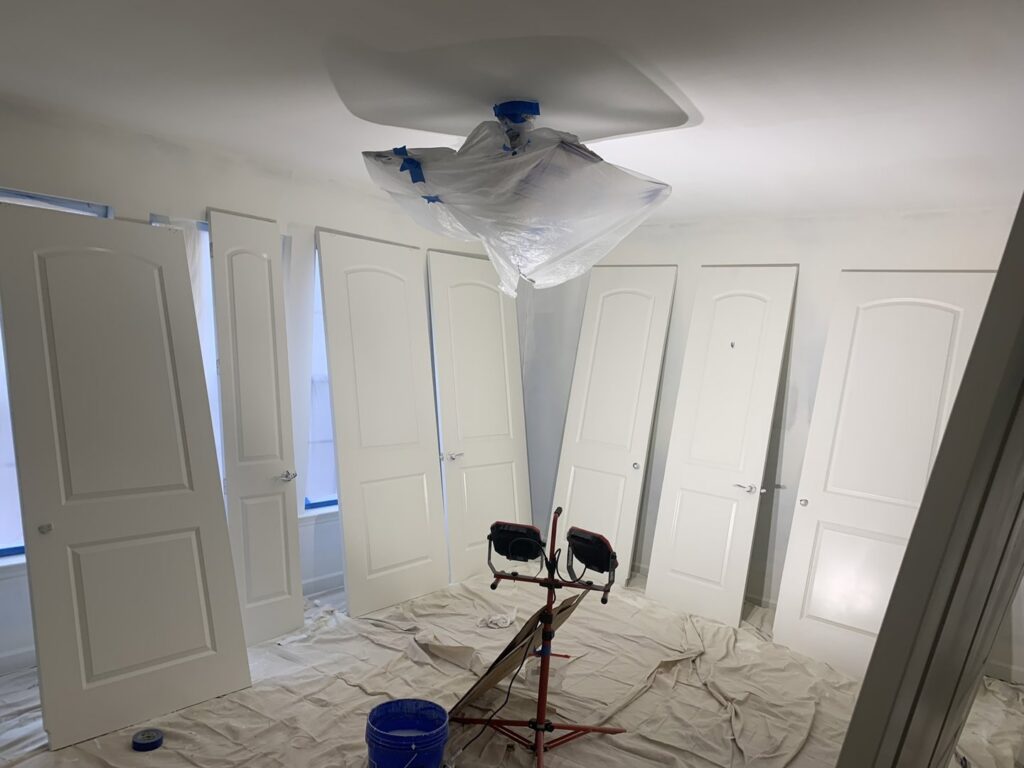 Several interior doors prepped for painting or installation in a room by Walrus Rock Construction LLC in Pacific, MO.