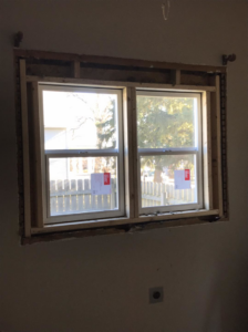 Interior view of a double window installation with wooden framing by Choice Contractors LLC in Fort Wayne, IN.